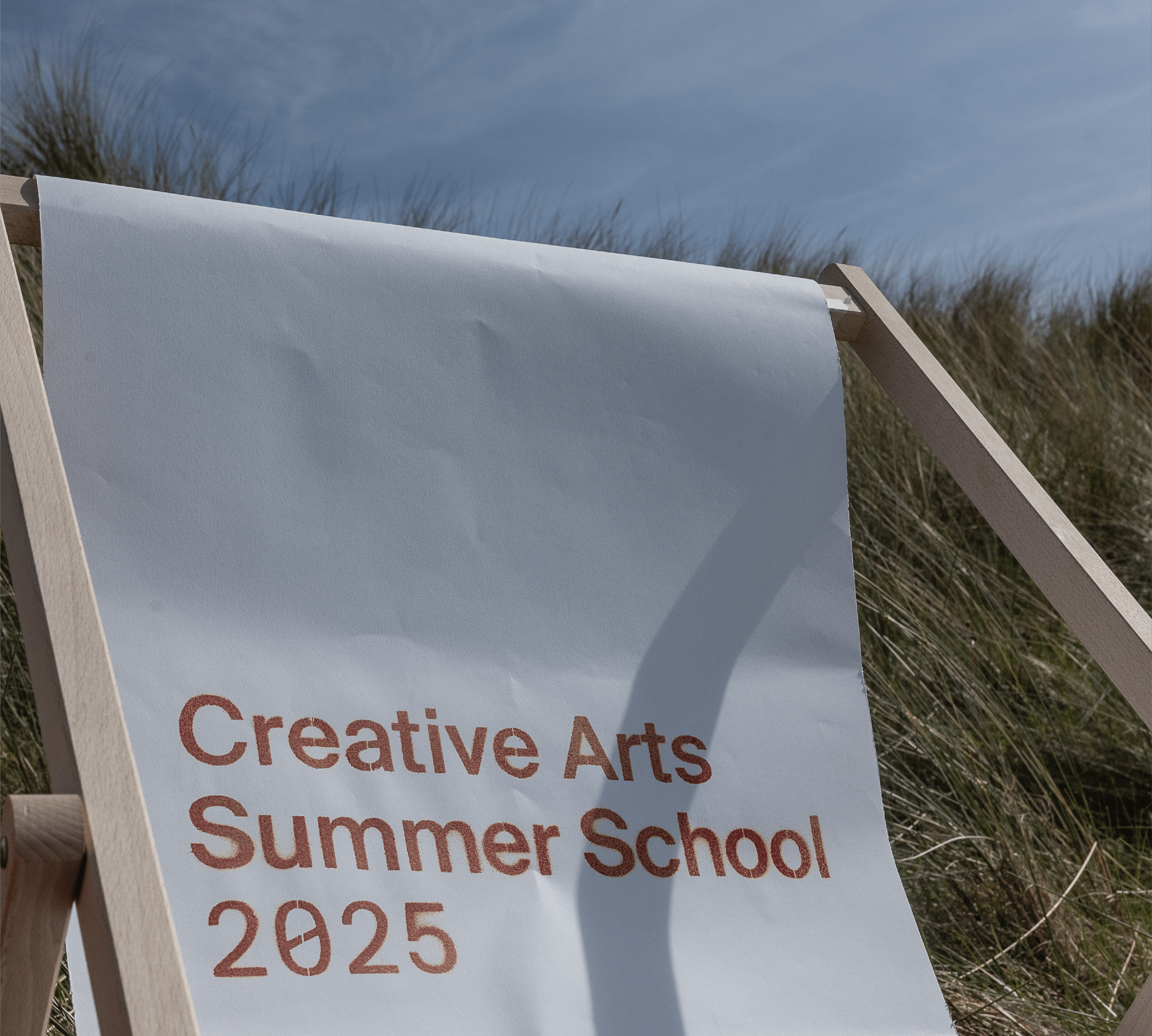 A chair branded with the creative art summer school 2025 logo.